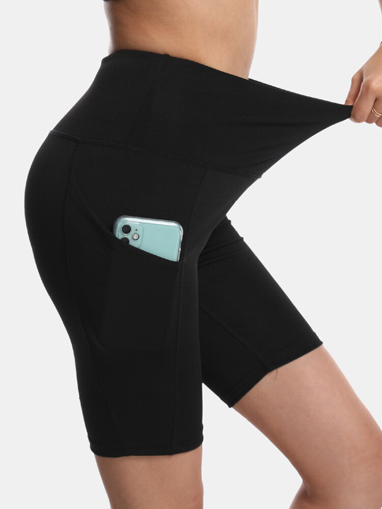 Sport Mujer Color sólido Elástico de cintura alta Yoga Pantalones cortos de motociclista con bolsillo