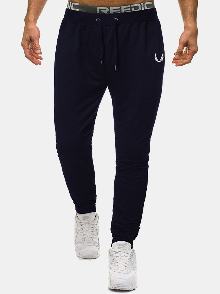 Jogger deportivo con cordón y bolsillo con estampado de color sólido de algodón para hombre Pantalones